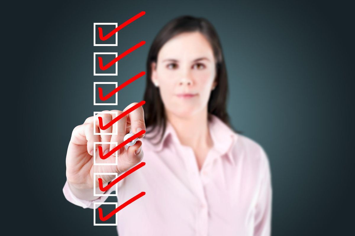 woman checking on checklist boxes