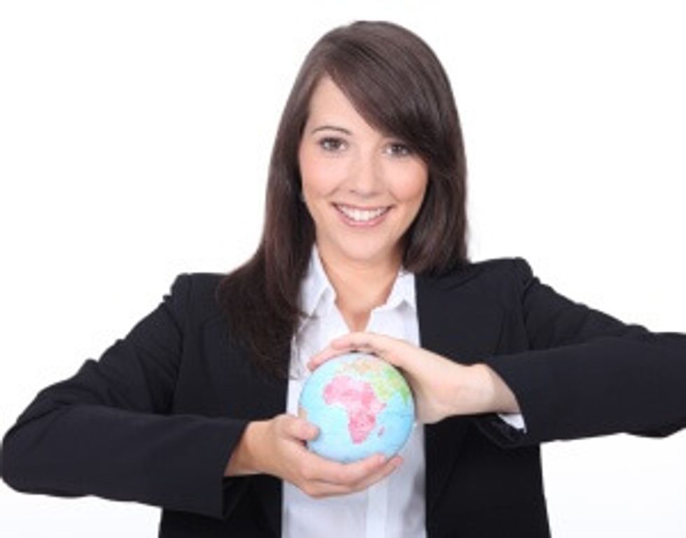woman holding globe ready to start exporting