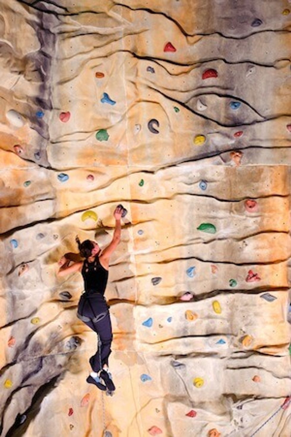 woman on rock wall