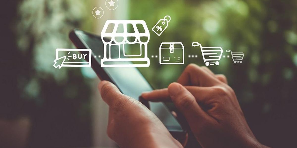 Woman's hand using smartphone make a website purchase