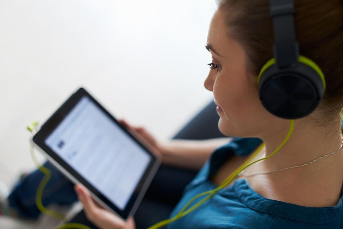 woman watches podcast on tablet