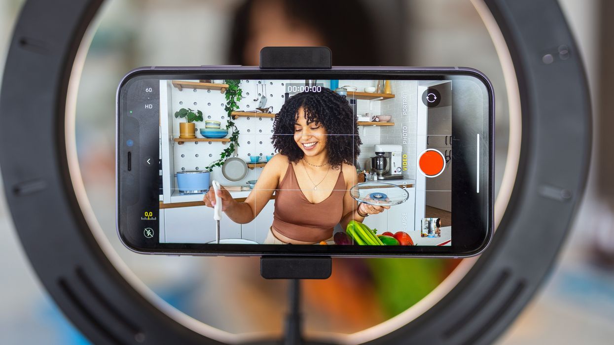 Woman with a food blog side hustle recording a video