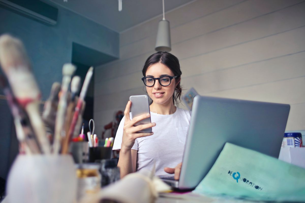 Woman works on Etsy side hustle at home