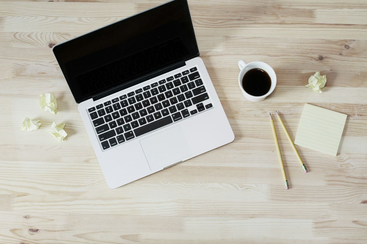 Writing good website content using a laptop and notepad