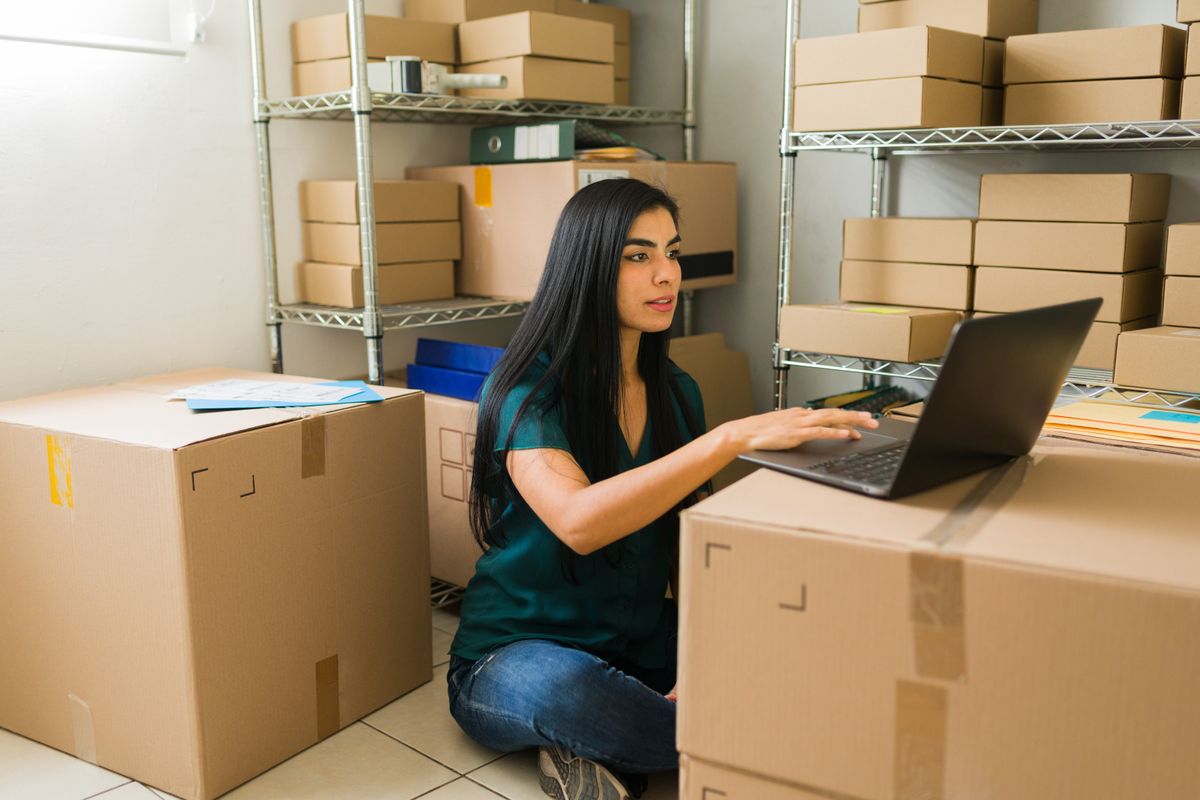 Young entrepreneur overseeing inventory to mitigate tariff impacts 