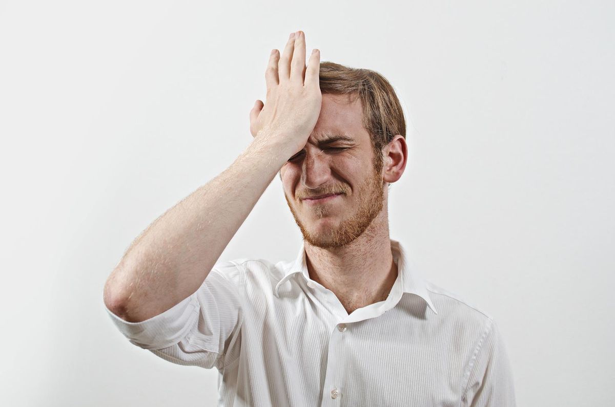 Young man gesturing made a big mistake