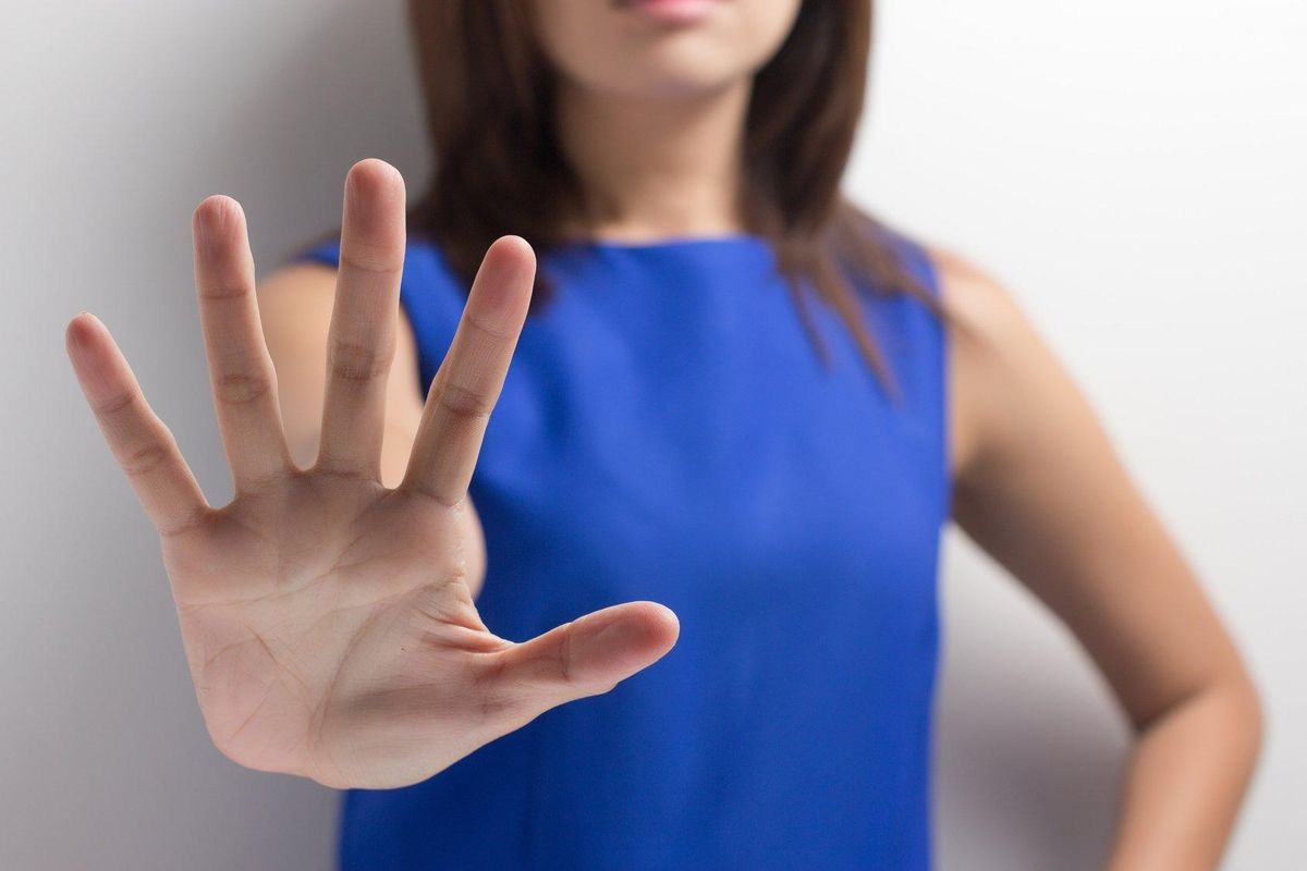 young woman showing her denial with NO on her hand